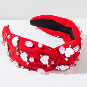 Detail of red knotted headband with rhinestone heart and arrow crystal ornaments