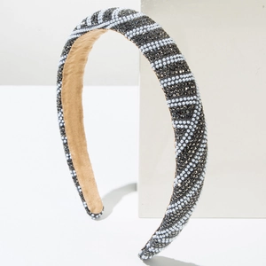 Detail shot of the wave-patterned headband with sparkling rhinestones and white faux pearls
