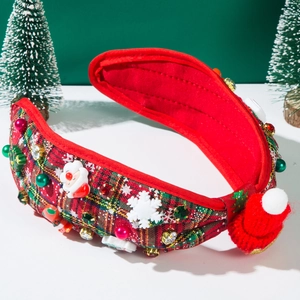 Detail of Christmas headband with red plaid fabric, mini Santa hat and jewel accents