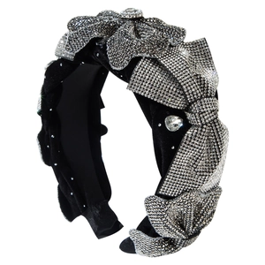 Elegant black velvet headband featuring a large bow and sparkling silver rhinestones