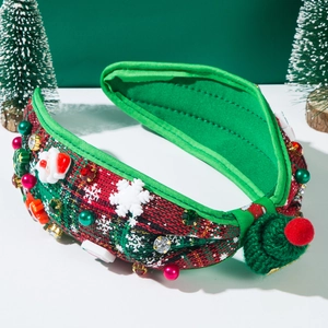 Close-up of a padded Christmas headband with red plaid fabric and pearl ornaments
