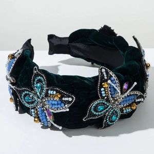 Detail of dark green velvet headband with handmade bead and jewel butterfly patterns