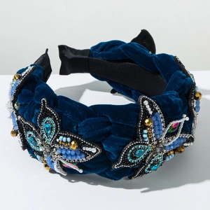 Close-up of velvet headband with butterfly bead embroidery and crystal details
