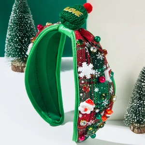 Detail of Christmas plaid headband with golden LOVE plush ball and holiday ornaments
