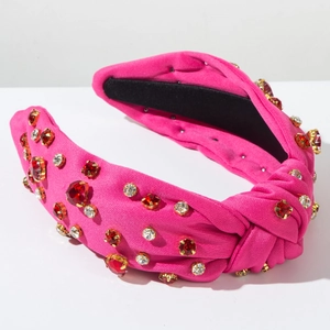 Detailed macro view of sparkling pink knot headband with vibrant crystals and sequins