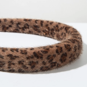 Close-up view of the leopard print faux fur texture and thick padded style of the headband