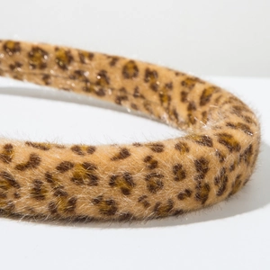 Close-up of leopard print faux fur headband with detailed plush texture and soft patterns