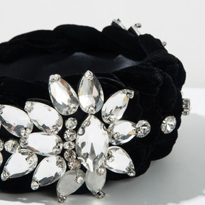 Macro shot of luxury black velvet braided headband with hand-sewn crystal floral details