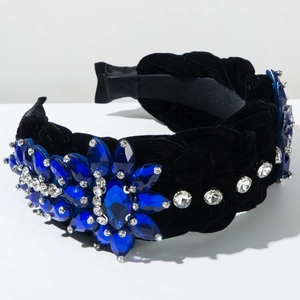 Close-up of luxury velvet braided headband with blue crystal flower and rhinestones
