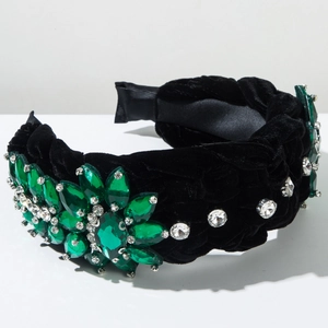 Close-up of woven velvet headband with emerald green crystals and flower details
