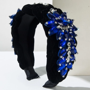 Luxury black velvet headband with blue and clear crystals on white geometric stand