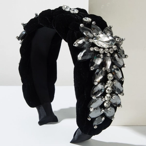 Detailed view of luxury black velvet headband with shimmering crystal rhinestone flowers