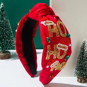 Detail of red knotted headband with 'HO HO HO' beaded embroidery and Christmas rhinestones
