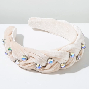 Close-up of pink velvet braided headband with sparkling colorful rhinestones detailing