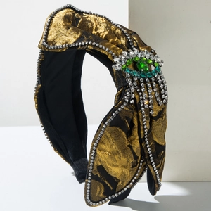 Serre-tête vintage en brocart avec nœud et ornement œil du démon serti de strass verts