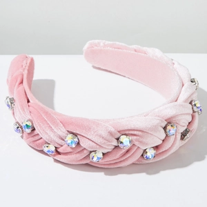 Macro detail of braided pink velvet headband decorated with sparkling colorful rhinestones