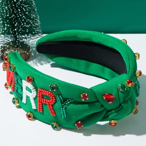 Detail of beaded MERRY letters and green rhinestones on festive Christmas headband