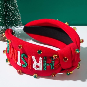Detail of red Christmas headband with handcrafted beads and green rhinestone letters
