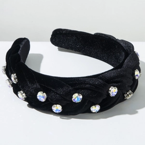 Macro detail of braided black velvet headband with colorful rhinestones on top