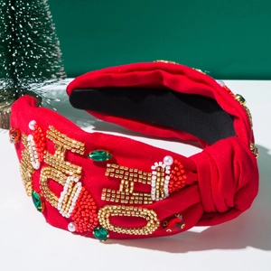 Detail of red Christmas headband with HO HO HO beadwork embroidery and green gems