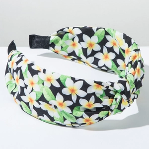 Detailed view of bohemian floral knot headband with white and yellow plumeria prints