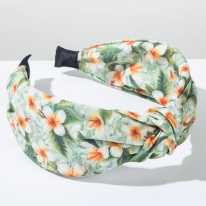 Detail of tropical plumeria print headband with a stylish top knot and fabric texture