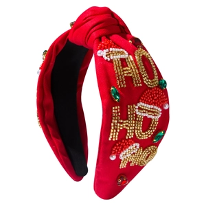 Red Christmas knotted headband with beaded HO HO HO letters and festive gems on white background