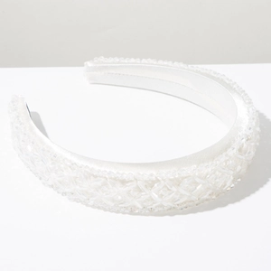 Detail of luxury white beaded headband featuring crystal grid embroidery on satin fabric
