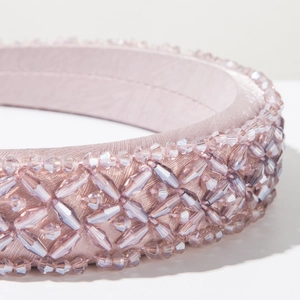 Close-up of lavender luxury baroque headband featuring hand-sewn crystal beads and satin texture