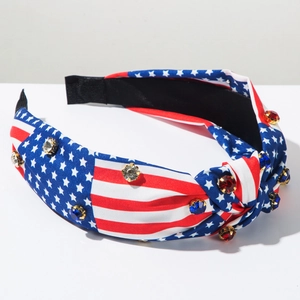 Close-up of knotted US flag headband with sparkling colorful rhinestones and gold claws