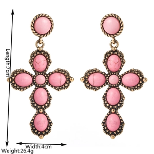 Detail showing 7cm length and 4cm width of retro cross earrings with pink turquoise inlay
