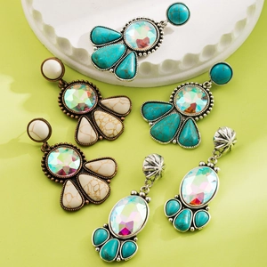 Detail of vintage bohemian earrings with turquoise stones and shimmering rhinestones
