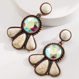 Macro detail of Bohemian long drop earrings with turquoise and iridescent crystal in bronze