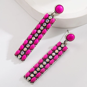 Detail of vintage bohemian earrings with pink stones and colorful rhinestones on silver base