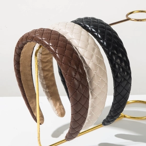 Quilted leather wide headband in brown, beige, and black with a high-top design