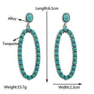 Detail view of vintage alloy earrings with blue turquoise beads and leopard print leather