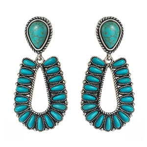 Western style turquoise double drop earrings with vintage silver frames on white background