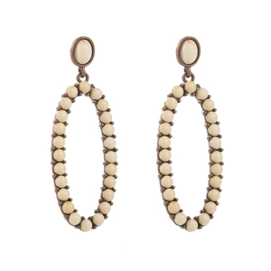 Close-up of vintage bronze leopard style earrings with inlaid white turquoise beads