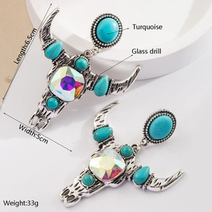 Vue détaillée de boucles d'oreilles crâne de taureau avec turquoise et cristal