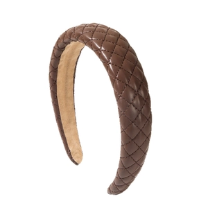 Classic dark brown wide leather headband with quilted diamond pattern in a minimalist style
