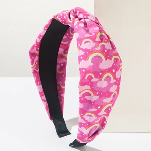 Detail van roze knoophoofdband met regenboog- en sterprint op twill katoenen stof