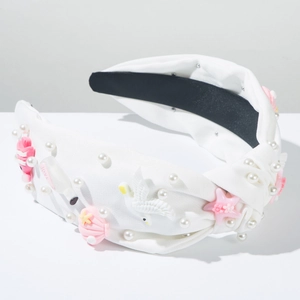 Détail du serre-tête thème océan avec étoiles de mer roses, coquillages et perles