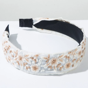 Detailed embroidery view of bohemian floral headband with gold and bronze threads