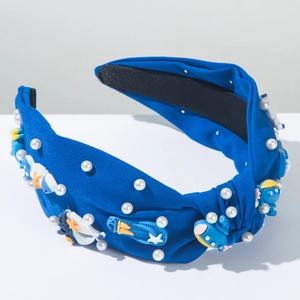 Détail du serre-tête noué bleu marine avec breloques marines en résine et perles