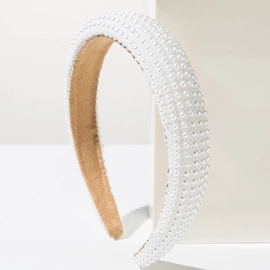 Elegant wide sponge headband with white pearls and brown velvet lining on white background