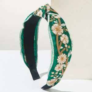Green knot headband with floral embroidery and gold sequins in bohemian style