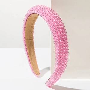 Detail of pink pearl sponge headband featuring a soft brown velvet lining and dense pearls