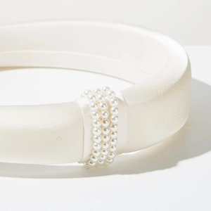Elegant white satin padded headband with triple row pearl accents on minimalist design