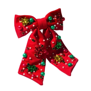 Weihnachtliche Haarspange mit roter Schleife, goldenen Sternen und festlichem Dekor