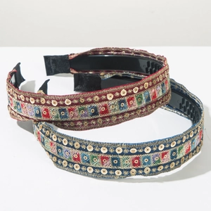 Close-up of Bohemian embroidered headbands with sequins and non-slip teeth detail